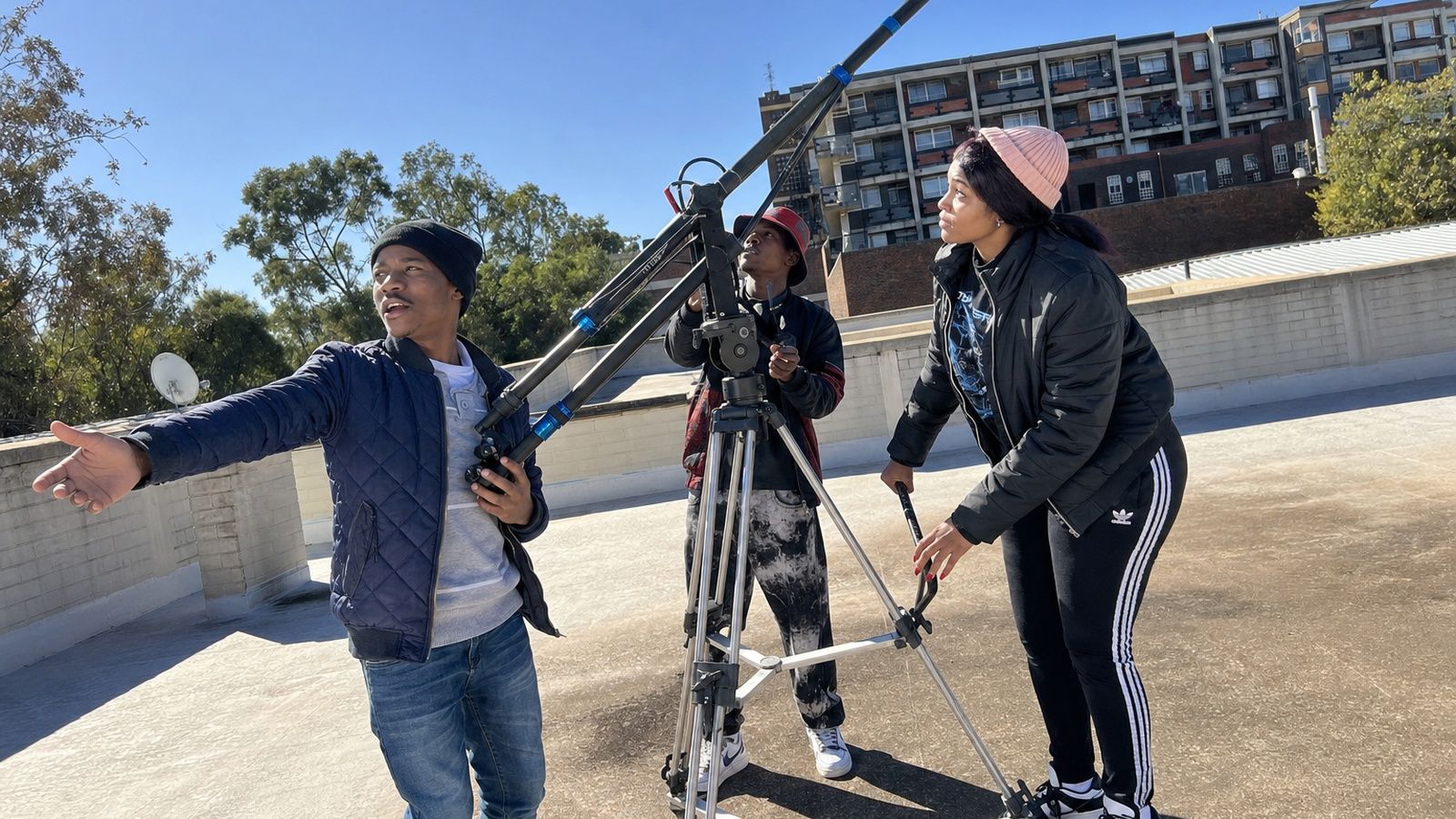 Film and TV students operating a camera crane on location