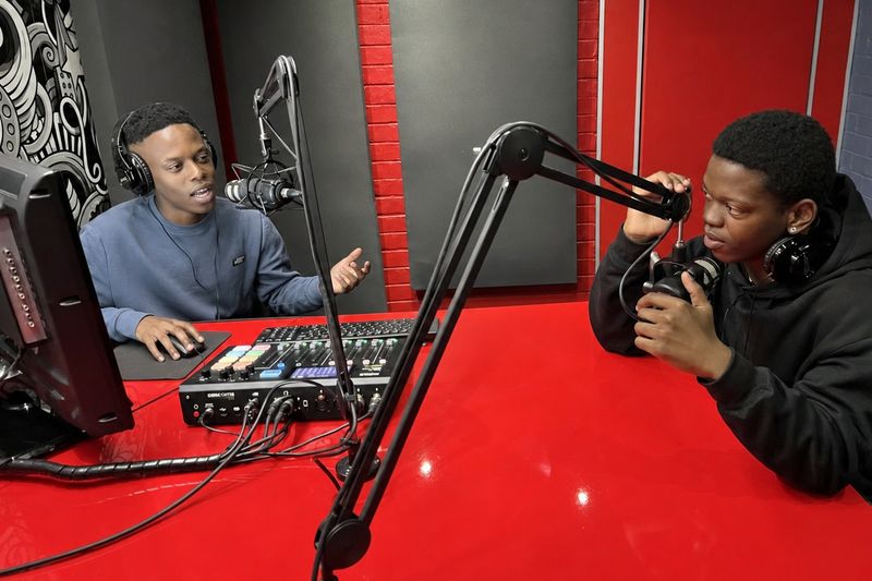 Students broadcasting live from the red PASMA radio studio